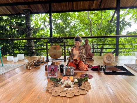 Cacao and sound healing ceremony in an open-air pavilion surrounded by jungle