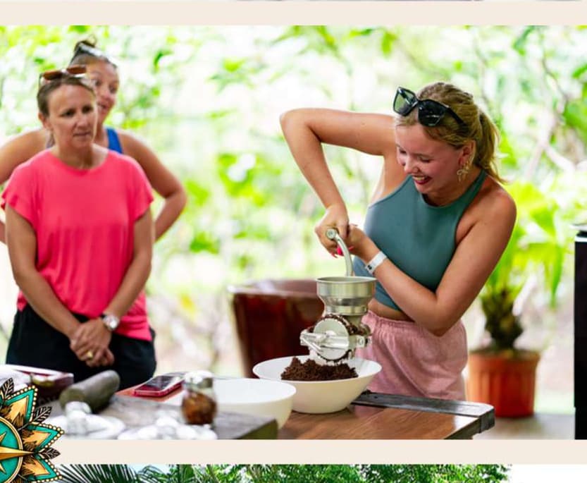 Retreat guests collaborating and laughing while preparing food together outdoors
